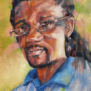 A portrait of a handsome African man with long hair braids and glasses and a kind face